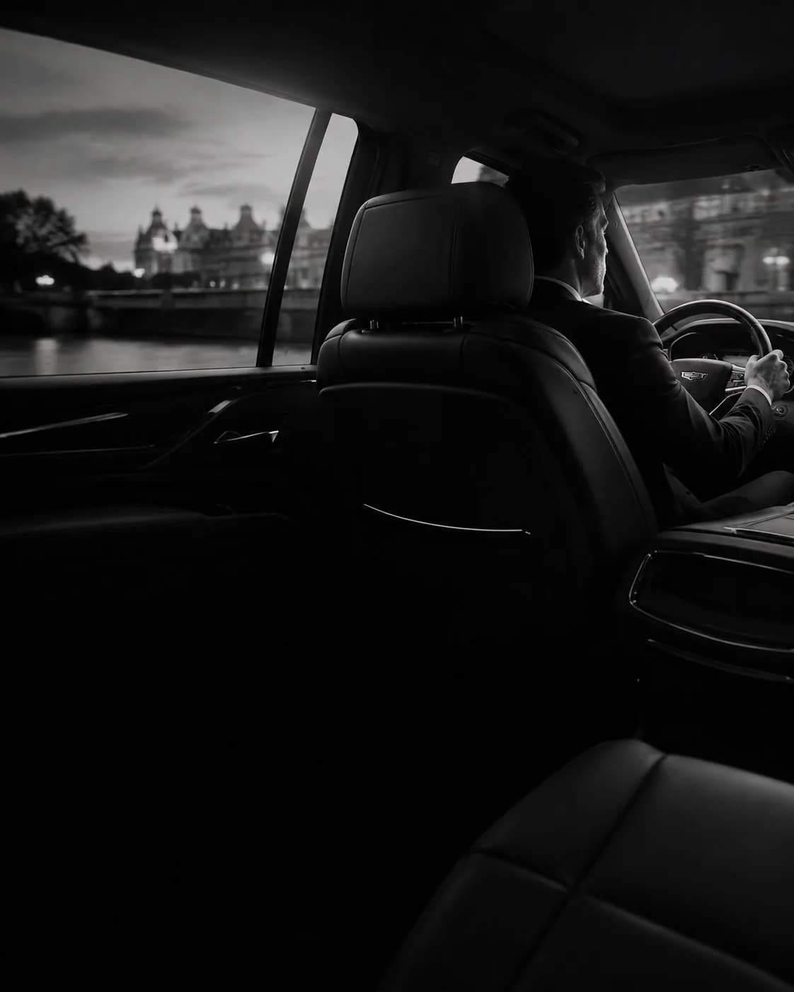 Car interior at night, with the chauffeur at the wheel